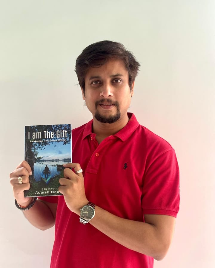 Adarsh Modi, published author of I am The Gift, holding his paperback