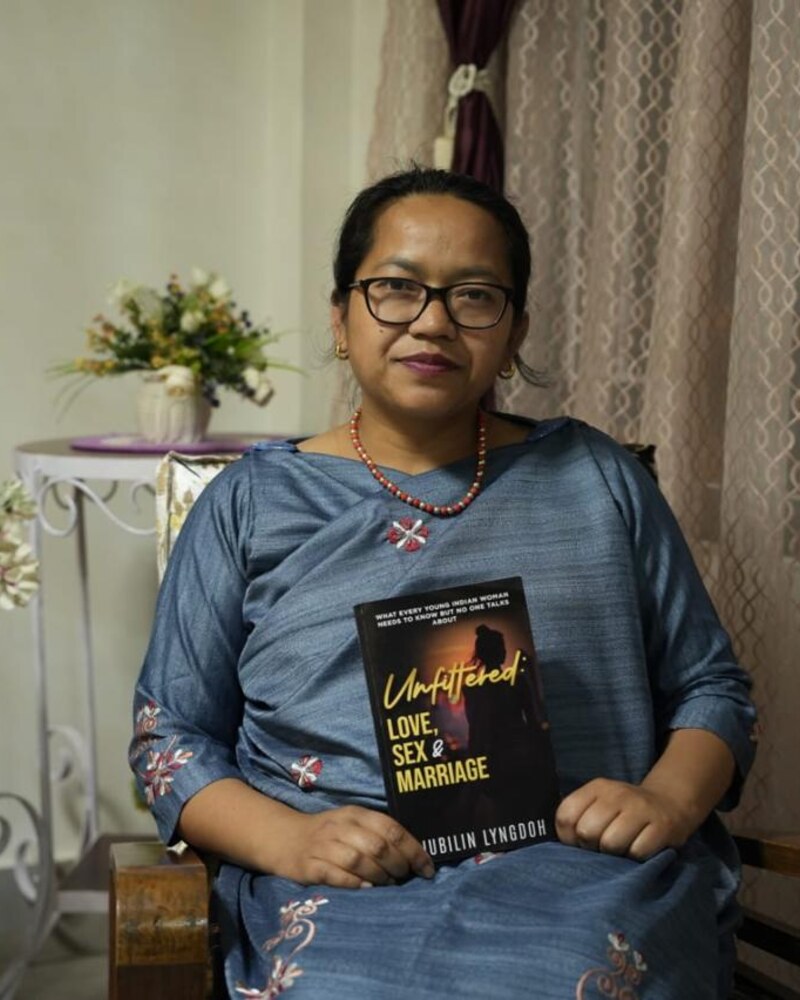 Jubilin Lyngdoh, published author of Unfiltered: Love, Sex & Marriage, holding her paperback